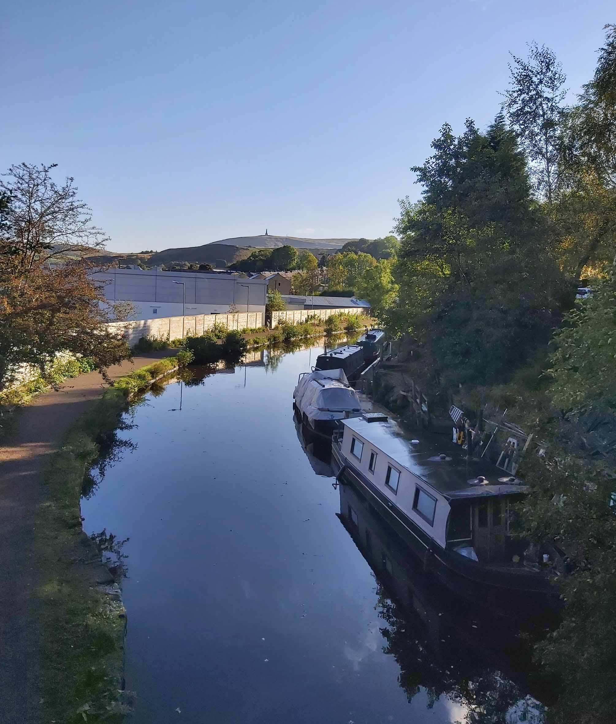 Beautiful view of Rochdale Canal and Stoodley Pike in the distance taken from centre of Todmorden